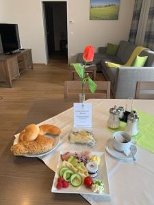 a table with two plates of food on it at Mattone Aparthotel in Lanzenkirchen