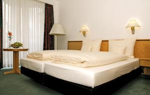 Un ou plusieurs lits dans un hébergement de l'établissement Matchpoint Hotel