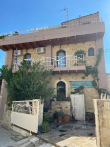 a house with a balcony on top of it at Villa Kamelia-Renovated old house-South Crete in Galiá