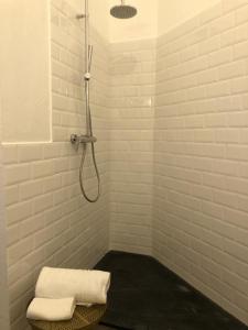 a bathroom with a shower with two towels on a stool at BB Palazzo Doria in Dolcedo