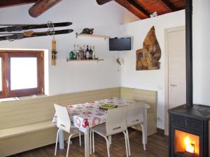 a dining room with a table and chairs and a fireplace at Holiday Home La tana del lupo by Interhome in Albonico