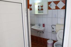 a small bathroom with a toilet and a sink at VILLA BORA in Leptokarya