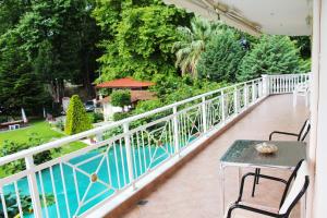 a balcony with a table and chairs and a pool at VILLA BORA in Leptokarya +7 photos