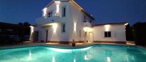 a villa with a swimming pool in front of a building at Villa Flavia in Aljezur