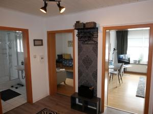 a living room with a room with a fireplace at Ferienwohnung Blumengarten in Marburg an der Lahn