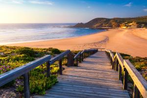 a wooden boardwalk leading to a beach at Villa Flavia in Aljezur