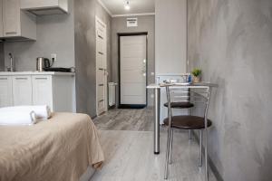 a room with a bed and a table and a kitchen at Guest house On Griboedova Street in Sochi