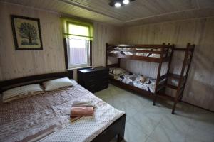 a bedroom with two bunk beds and a window at Маєток Мигдаль in Svityazʼ