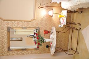 a bathroom with a mirror and a hair dryer at Royal Apartments in Niš