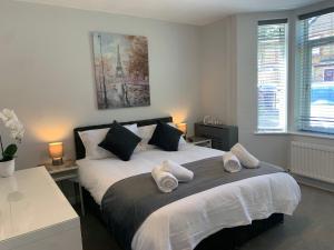 a bedroom with a large bed with two pillows at Eclipse Apartment No 3 in Newmarket