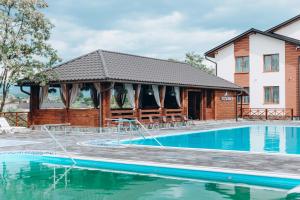 a house with a swimming pool and a building at Sofion hotel&resort in Solotvyno +67 photos