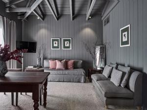 a living room with a couch and a table at The Kefalari Suites in Athens