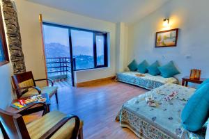 a living room with a bed and a couch at Rosewood Retreat Bhimtal in Bhīm Tāl