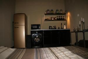 a kitchen with a refrigerator and a washing machine at Smart Apartments in Budapest