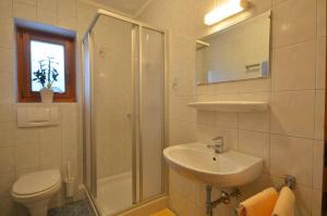 a bathroom with a shower sink and a toilet at Landhaus Mitteregger in Kaprun +32 photos