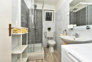a bathroom with a shower and a toilet and a sink at Apartments Marsela in Tučepi +65 photos