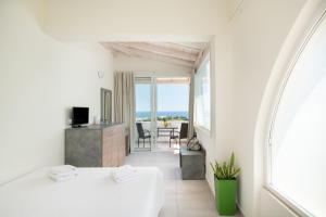 a white room with a view of the ocean at Sunday Life in Agia Pelagia