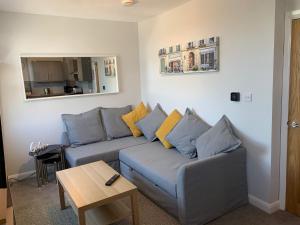 a living room with a couch and a table at Eclipse Apartment No 4 in Newmarket