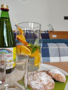 a table with a plate of food and a bottle of wine at Bio Agritur al Bait in Spormaggiore +17 photos