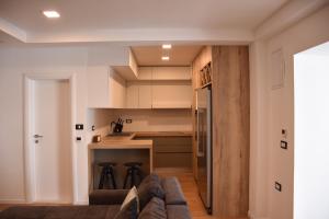 a living room with a couch and a kitchen at Apartman Lucana in Tribunj