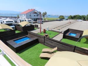 an overhead view of a patio with two pools and grass at Osaka Hokko Marina HULL in Osaka