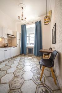 a kitchen with a table and a chair at Scandinavian Apartments in Kyiv