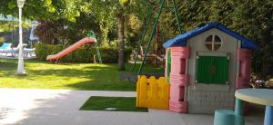 a small toy house in a yard with a playground at Arouca Passadiços Alojamento in Arouca