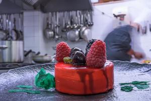 a red block with raspberries on top of it at Best Western Premier Villa Fabiano Palace Hotel in Rende