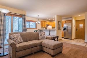 a living room with a couch and a kitchen at 1100 Flying Dutchman condo in Keystone