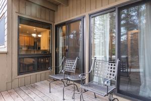 two chairs sitting on the front porch of a house at 1100 Flying Dutchman condo in Keystone