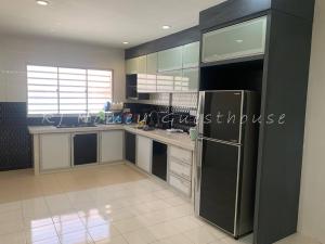 a kitchen with a stainless steel refrigerator and cabinets at RJ Homey Guesthouse in Sungai Petani