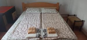 a bedroom with a bed with two mitts on it at Kuća za odmor Ema in Vrnjačka Banja