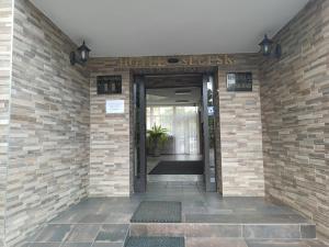 an entrance to a hotel with a brick wall at Hotel Słupsk in Słupsk