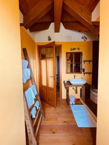 a bathroom with two bunk beds and a sink at Casa Brencio in Masera