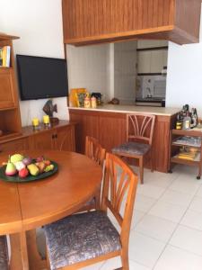 a kitchen with a table with a plate of fruit on it at T1 - Praia da Rocha - com Vistas de Mar e Terraço in Portimão