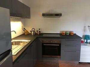 a kitchen with a sink and a stove top oven at Stunning medieval setting surrounded by mountains in Castelbianco +23 photos