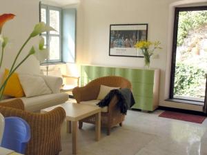 a living room with a couch and chairs and a table at Oliveto Sleeps 4 with Private Garden in Castelbianco +13 photos
