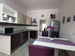 a kitchen with a table and a refrigerator at More in Malinska