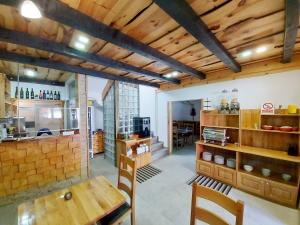 a kitchen with a wooden table and chairs in a room at Plitvice Ethno House in Jezerce