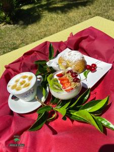 a table with a plate of food and a cup of coffee at Hotel Mille Pini in Ginosa Marina