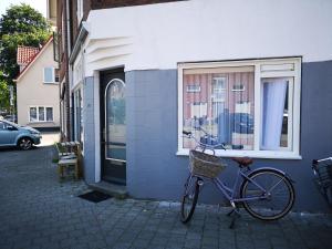 a bike parked next to a building with a window at Studio Huzur in Deventer