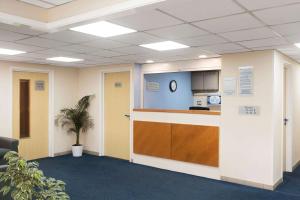 an office cubicle with a counter and a kitchen at Days Inn Sutton Scotney South in Sutton Scotney