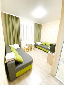 a hotel room with two beds and a table at Посуточная аренда жилья in Mohyliv-Podilʼsʼkyy