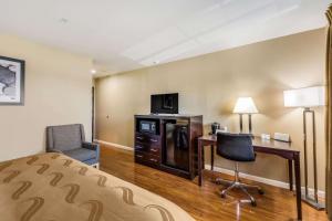 a hotel room with a bed and a desk and a chair at Quality Inn Cle Elum-Ellensburg in Cle Elum