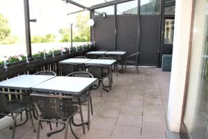 a row of tables and chairs on a patio at Hotel Waldschlösschen in Dankmarshausen