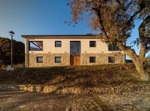 uma casa de tijolos com uma árvore em frente em CASA SARTZALETA-Navarra-España em Aramendía