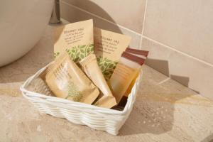 a basket filled with books sitting on a counter at La Corte Di Pulicinu in Baja Sardinia