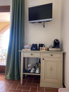 a table with a tv on top of a wall at Villa Alba in Marciana Marina +19 photos
