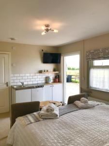 a bedroom with a bed with towels on it at The Stables self catering in Seahouses