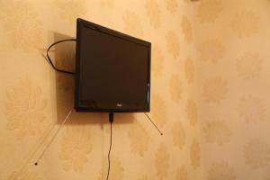 a flat screen tv hanging on a wall at Гостевой дом in Gagra